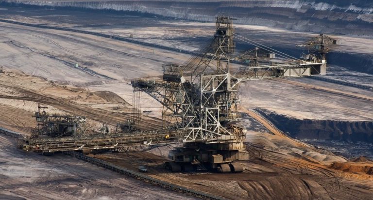 Large industrial mining excavator in an open-pit mine.
