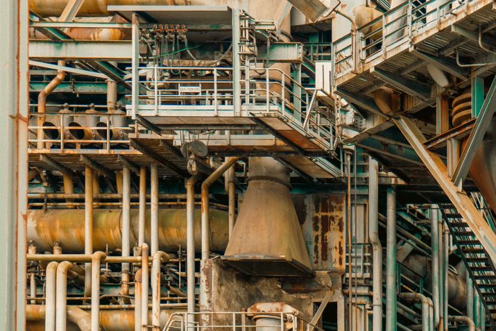 Complex industrial structure with pipes and metal frameworks.